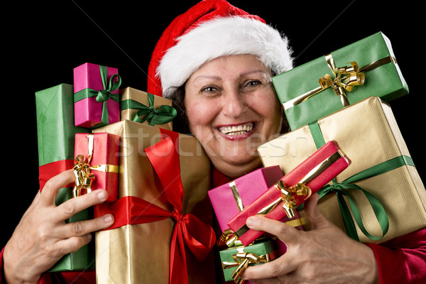 Cheerful Aged Woman Embracing Wrapped Presents 
 Stock photo © leowolfert