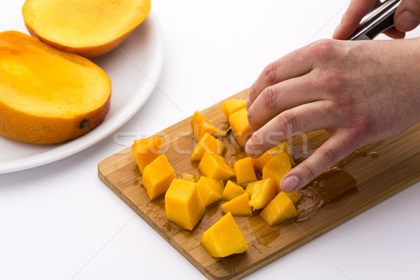 Juicy Mango Fruit Pulp Diced On A Kitchen Board Stock photo © leowolfert