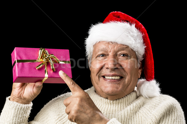 Joyous Old Man Pointing At Magenta Wrapped Gift Stock photo © leowolfert