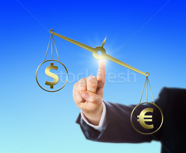 Euro Sign Outweighing The Dollar On A Balance Stock photo © leowolfert