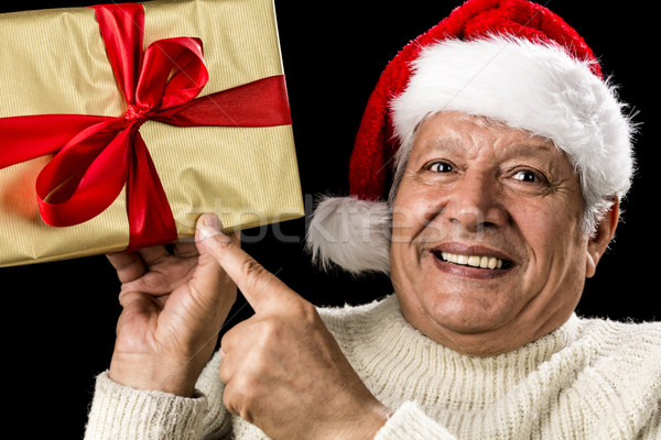 Excited Aged Man Pointing At Golden Gift In Hand Stock photo © leowolfert