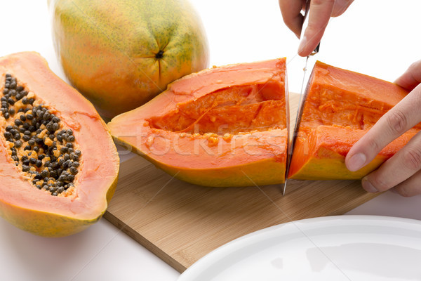 First Cut Through A Hollowed Out Papaya Half Stock photo © leowolfert