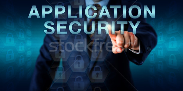 Executive Pushing APPLICATION SECURITY Onscreen Stock photo © leowolfert