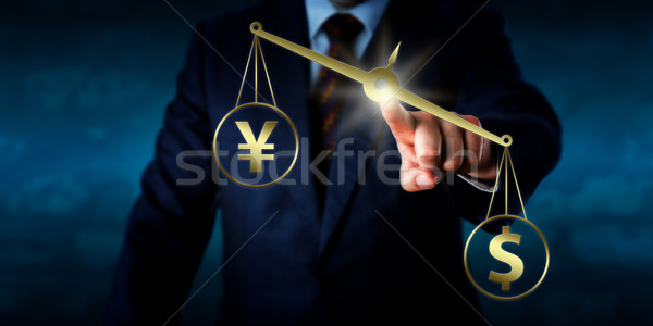 US Dollar Outweighing The Yuan On A Golden Scale Stock photo © leowolfert