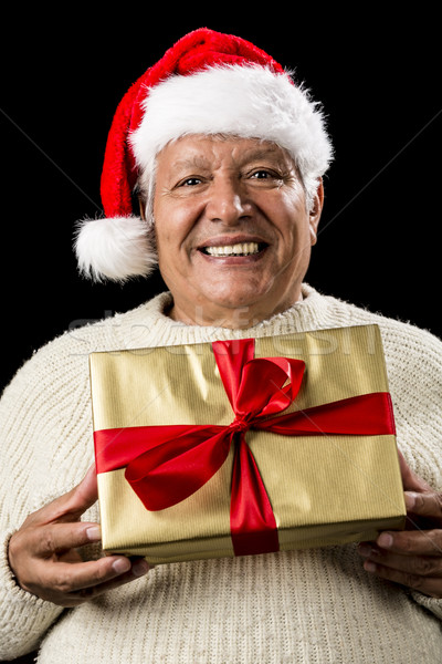 Grey-Haired Man Offering Golden Wrapped Present Stock photo © leowolfert