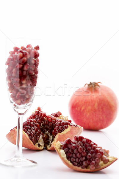 Pomegranate seeds and a whole Punica granatum
 Stock photo © leowolfert