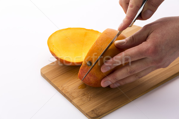 Kés második vág mangó kettő kezek Stock fotó © leowolfert