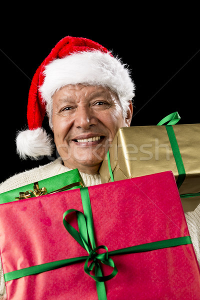 Aged Gentleman Peering Across Three Wrapped Gifts Stock photo © leowolfert