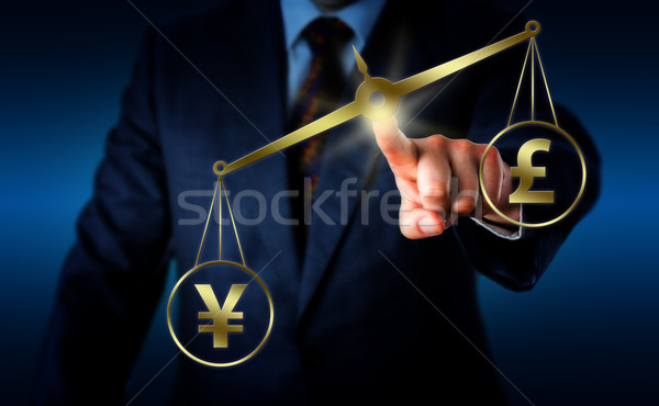 Yuan Sign Outweighing The Pound On A Balance Stock photo © leowolfert