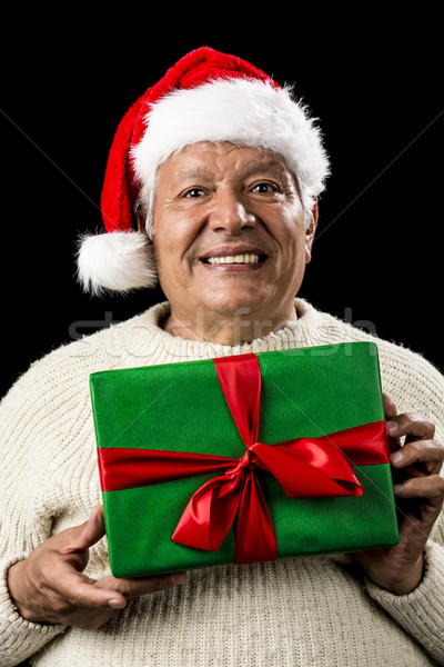 Male Senior With Santa Claus Cap and Green Gift Stock photo © leowolfert