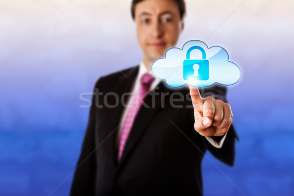 Sorridente empresário tocante trancado ícone nuvem para a frente Foto stock © leowolfert