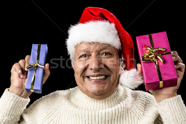 Euphoric Old Man With Two Presents And Santa Hat Stock photo © leowolfert