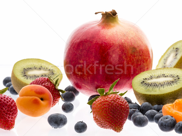 Halved Kiwi Fruits And Berries On White Background Stock photo © leowolfert