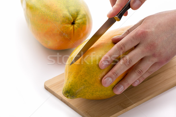 Knife Positioned For A First Cut Through A Papaya Stock photo © leowolfert