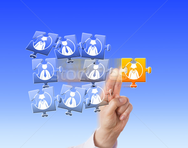 Hand Singling Out A Worker In A Jigsaw Puzzle Stock photo © leowolfert