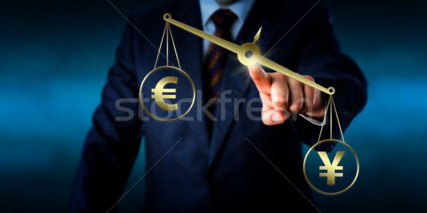 Yuan Sign Outweighing The Euro On A Golden Scale Stock photo © leowolfert