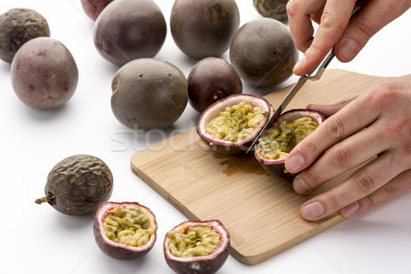 Halving Passion Fruits With A Kitchen Knife Stock photo © leowolfert