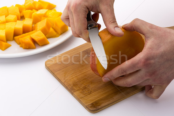 Peeling The Middle Mango Slice With The Fruit Pit Stock photo © leowolfert