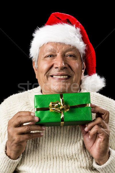 Smiling Old Man Handing Over A Wrapped Green Gift Stock photo © leowolfert