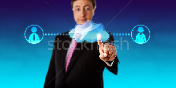 Smiling Businessman Contacting Workers Via Cloud Stock photo © leowolfert