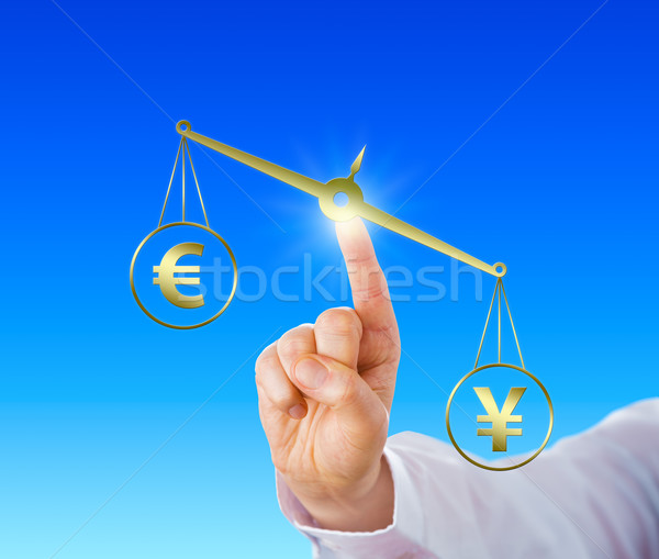 Yen Sign Outweighing The Euro On A Golden Scale Stock photo © leowolfert