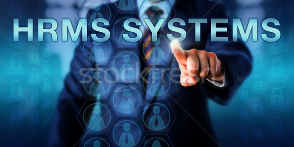 HR Manager Pushing HRMS SYSTEMS Onscreen  Stock photo © leowolfert