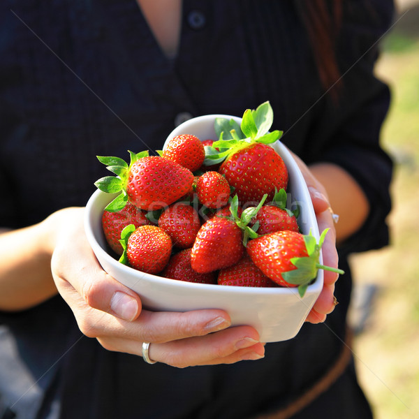 strawberry in heart shape bowl with hand Stock photo © leungchopan