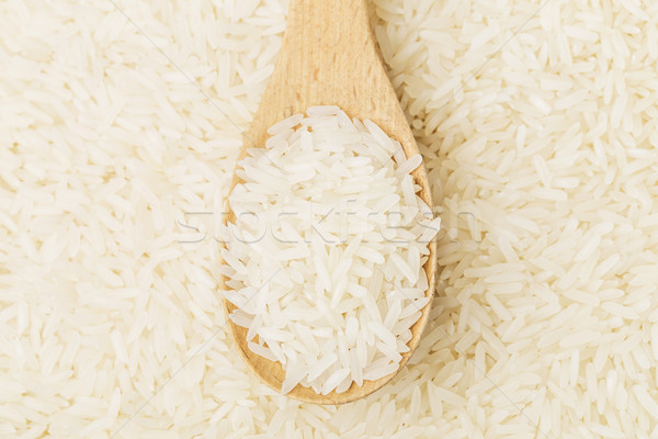 Uncooked rice on spoon Stock photo © leungchopan
