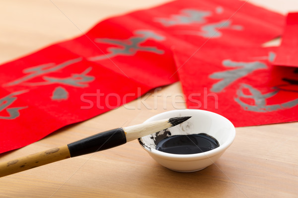 Writing the couplet for chinese new year Stock photo © leungchopan