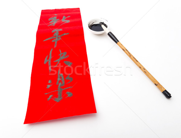 Writing of Lunar new year calligraphy, phrase meaning is happy n Stock photo © leungchopan