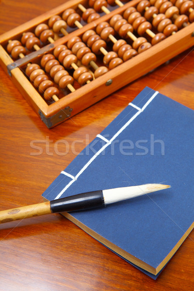 Stock photo: Chinese book , abacus and writing brush