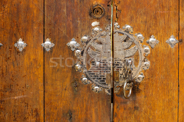 Metallic door knob with wooden door Stock photo © leungchopan