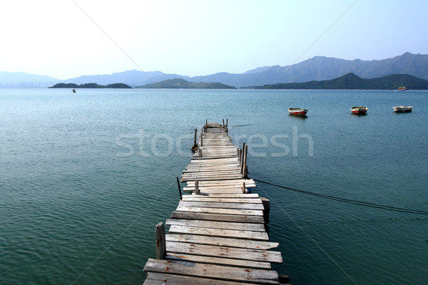 Looking over a pier and a boat Stock photo © leungchopan