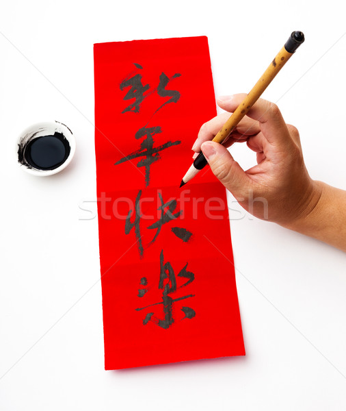 Stock photo: Writing of chinese new year calligraphy, phrase meaning is happy