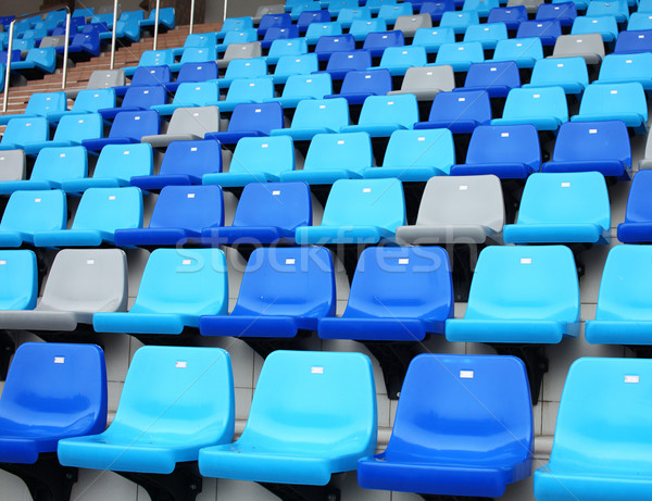 blue plastic old stadium seats on concrete steps Stock photo © leungchopan