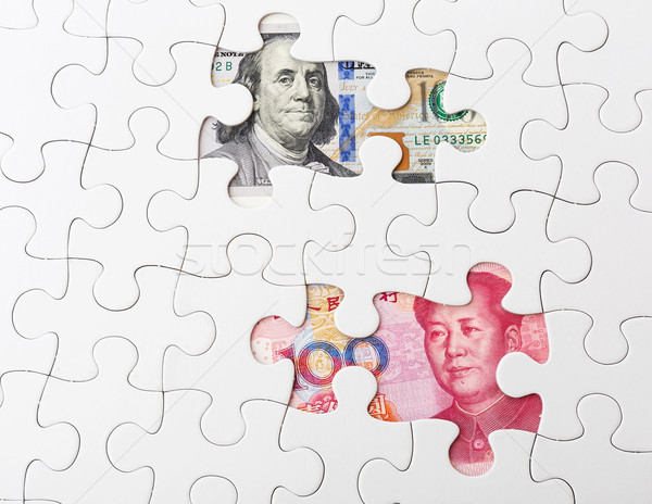 White puzzle with US and chinese banknote Stock photo © leungchopan