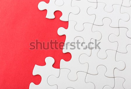 White jigsaw over red background Stock photo © leungchopan