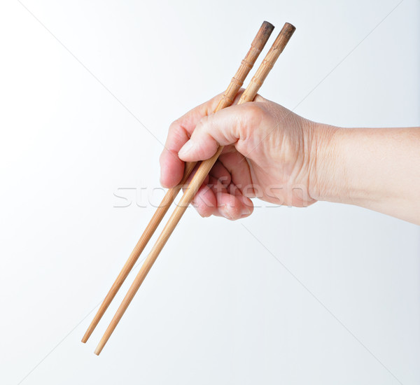 hand using chopsticks Stock photo © leungchopan