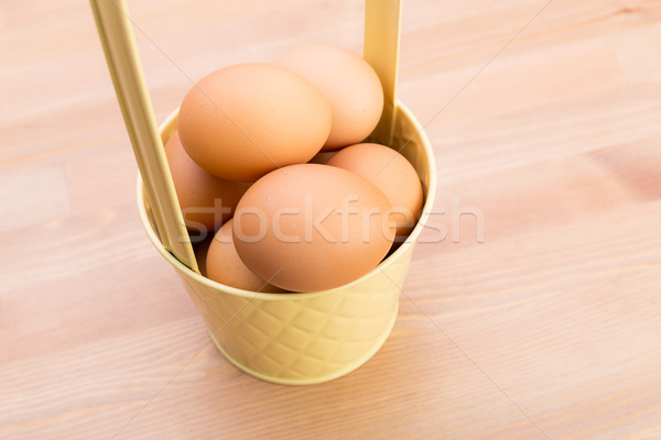 Brown egg in bucket Stock photo © leungchopan