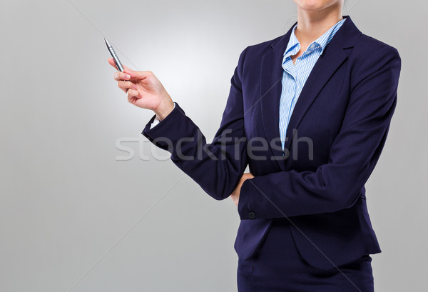Businesswoman with pen point up Stock photo © leungchopan