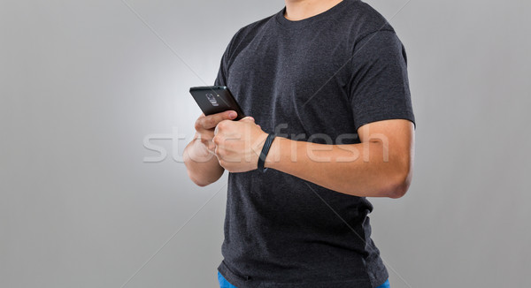 Man use mobile phone sync with wearble device Stock photo © leungchopan