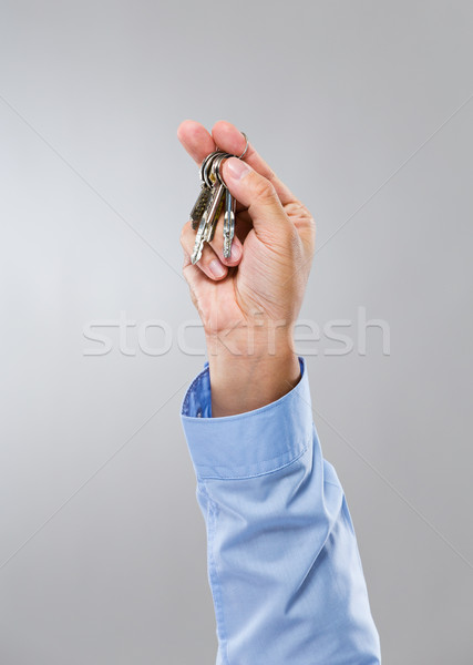 Businessman hand hold with key Stock photo © leungchopan