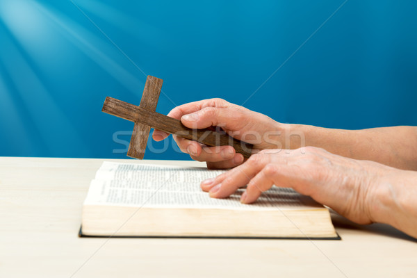 Christian praying with hands folded and fingers crossed with Hol Stock photo © leventegyori