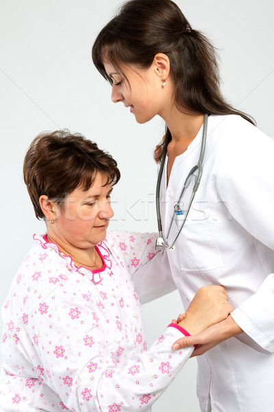 Helping senior woman getting up Stock photo © leventegyori