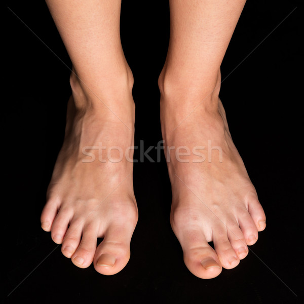 Foot care on black background Stock photo © leventegyori