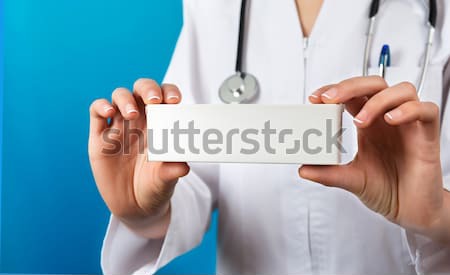Stock photo: Doctor showing a pill packet to the patient