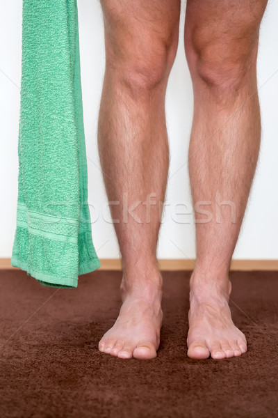 Healthy male feet with towel stepping towards the bathroom. Stock photo © leventegyori