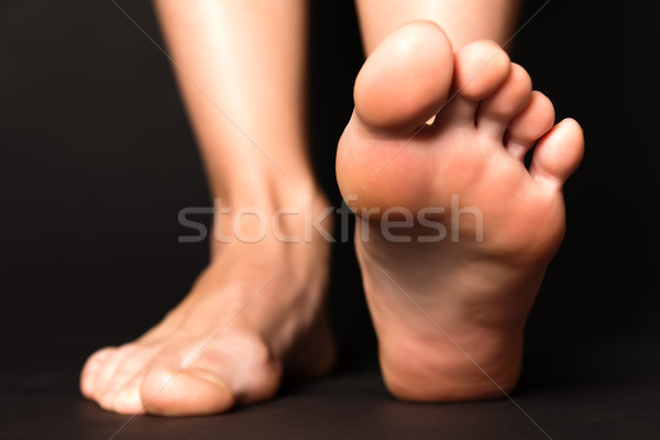 Foot stapping isolated on black Stock photo © leventegyori