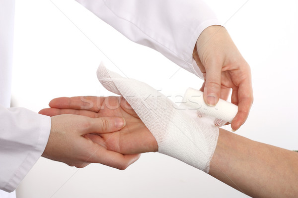 Doctor cover the hand of patient by bandage Stock photo © leventegyori