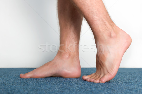 Healthy male feet feeling comfortable at home. Stock photo © leventegyori